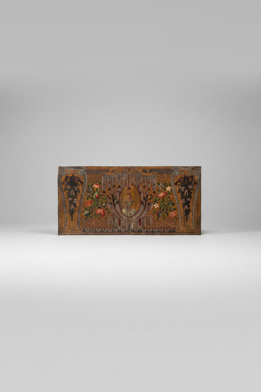 An antependium with stamped leather, featuring gilded, silvered, and polychrome painted details. It includes a central cartouche with the baptism of Christ, framed with palms, canopies, and drapery, surrounded by flowers and foliage.