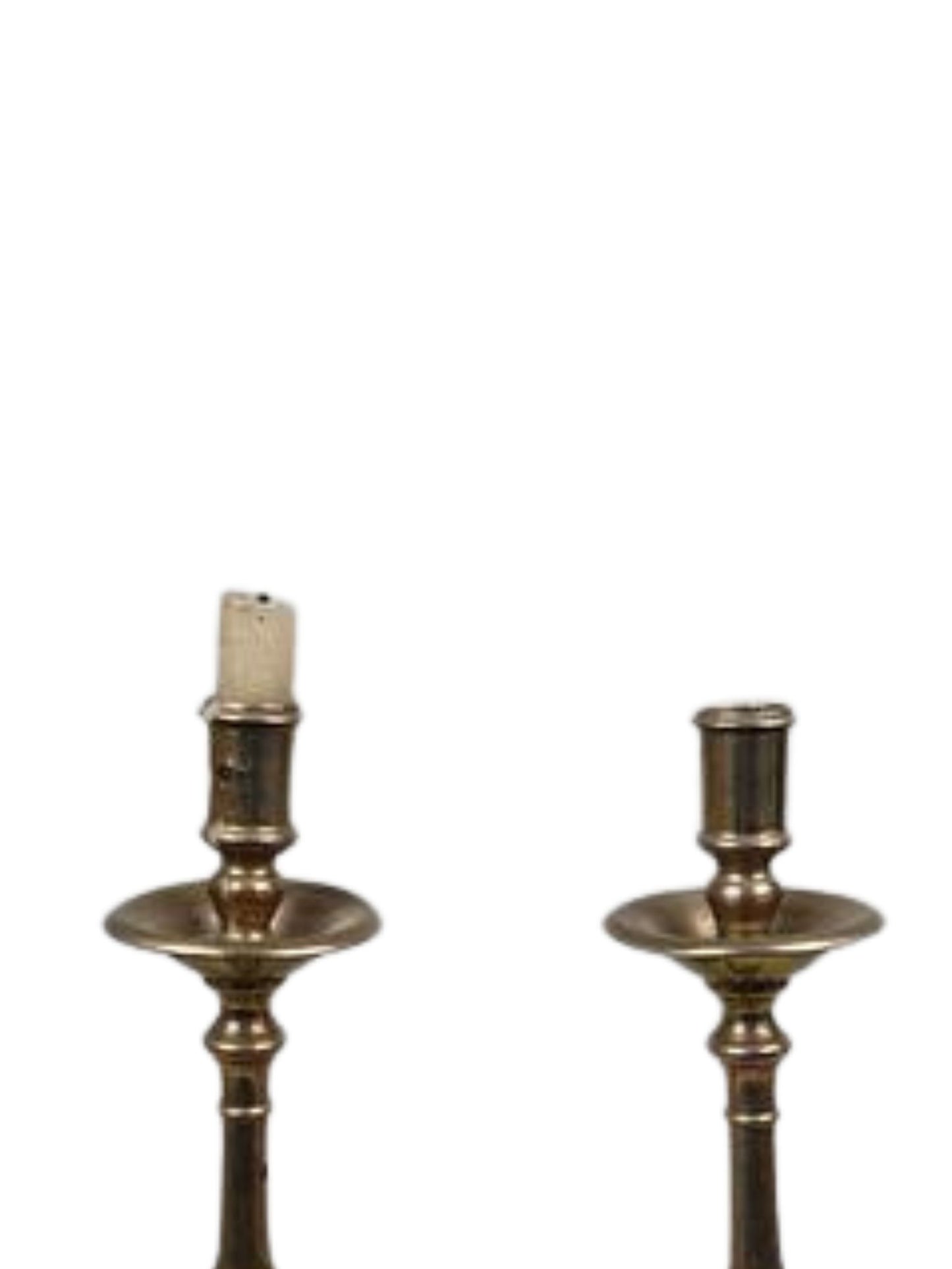 Pair of brass candle holders on a white background