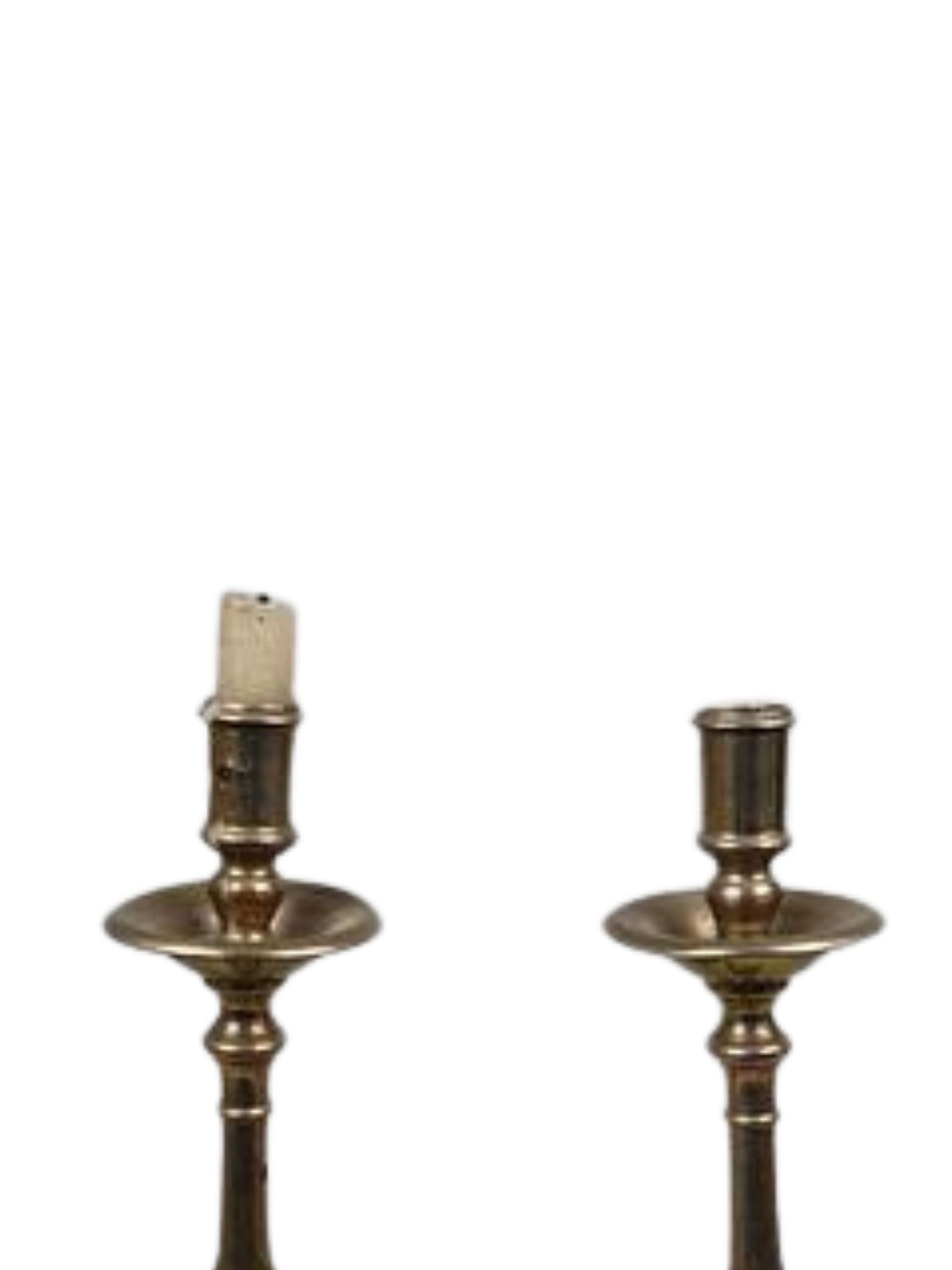Pair of brass candle holders on a white background